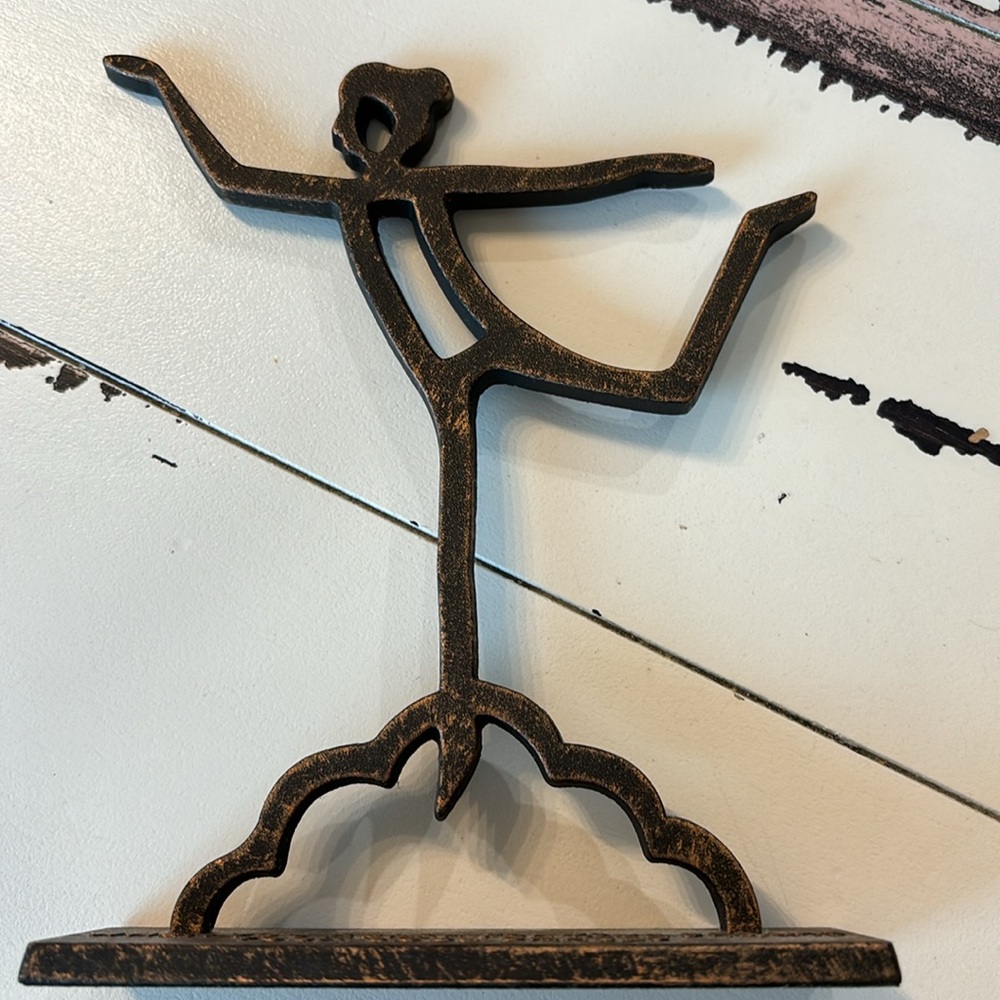 “When you reach for your dreams, your soul dances” metal statue
